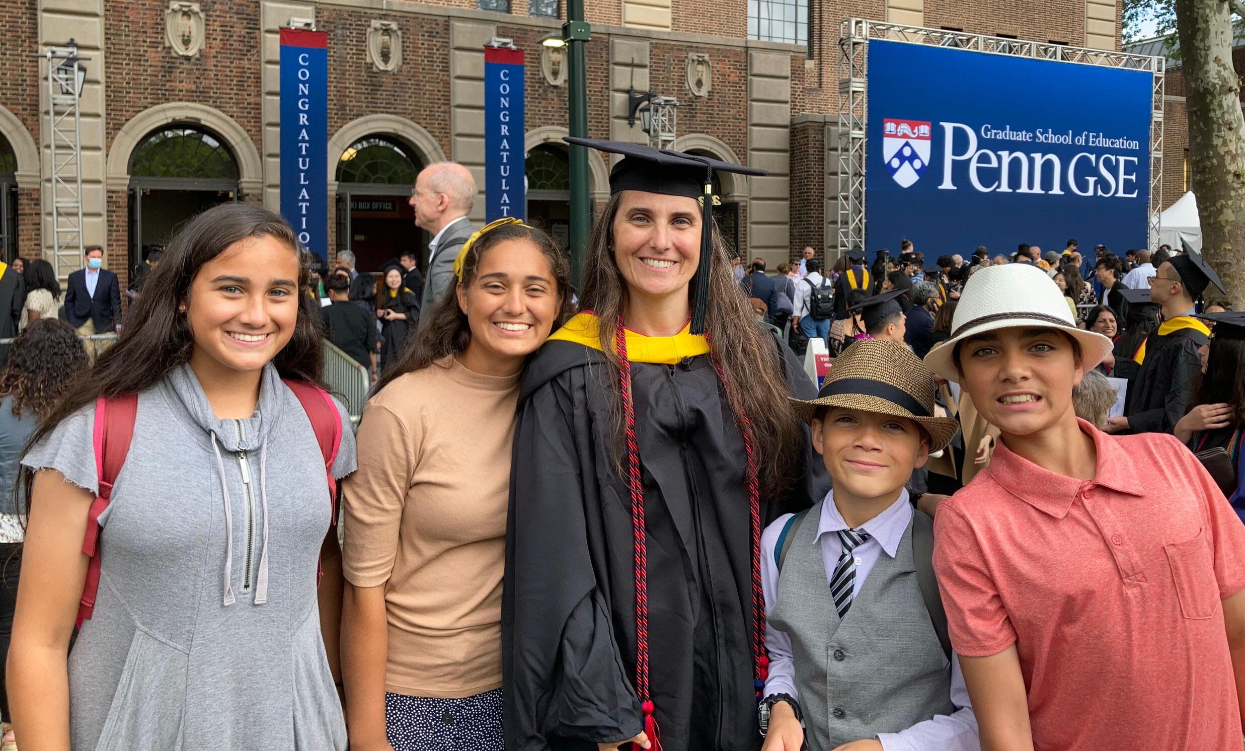 Melissa & her kids at her Master's graduation. Penn. May 2022